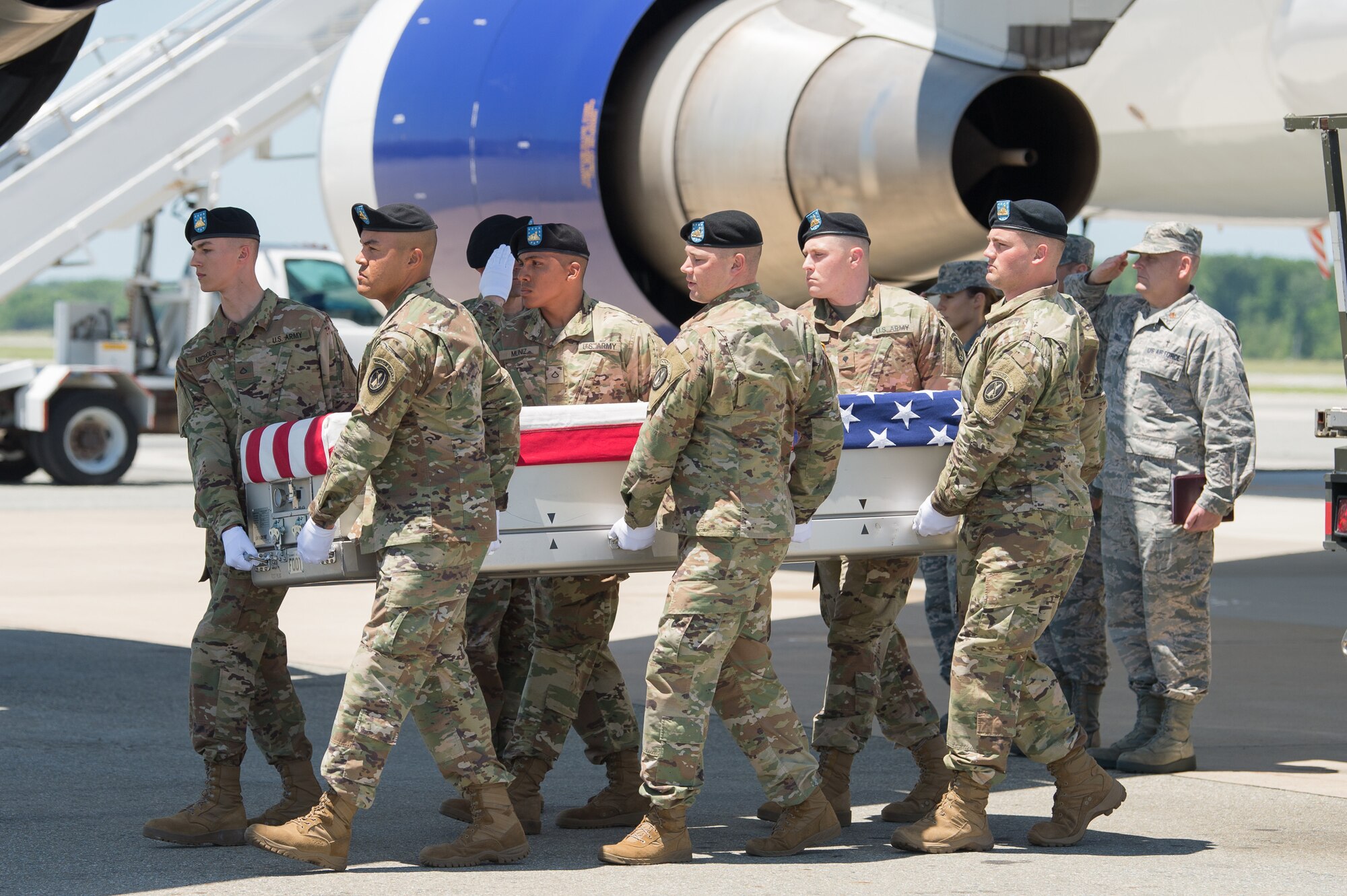 Army carry team transfer remains of Army Staff Sgt. Alexander W. Conrad.