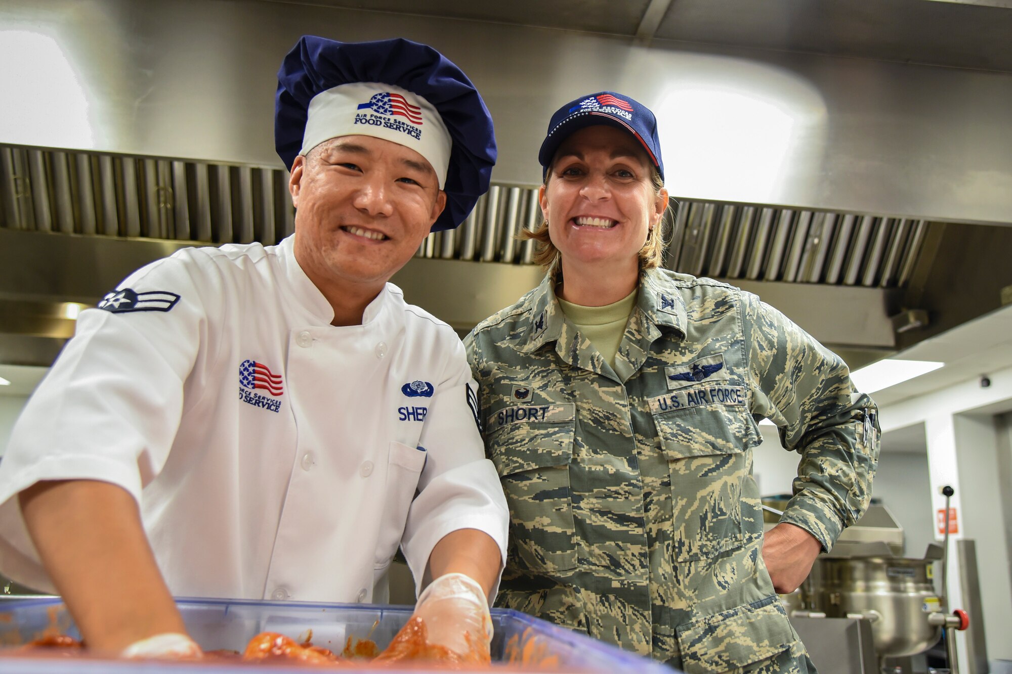 Airman 1st Class Pema Sherpa, left, 23d Force Support Squadron services journeyman, and Col. Jennifer Short, 23d Wing (WG) commander, pose for a photo during an immersion tour, June 11, 2018, at Moody Air Force Base, Ga. Short and Chief Master Sgt James Allen, 23d WG command chief, toured the Georgia Pines Dining Facility and the Information Learning Center to gain a better understanding of their overall mission, capabilities and comprehensive duties. (U.S. Air Force photo by Airman 1st Class Eugene Oliver)