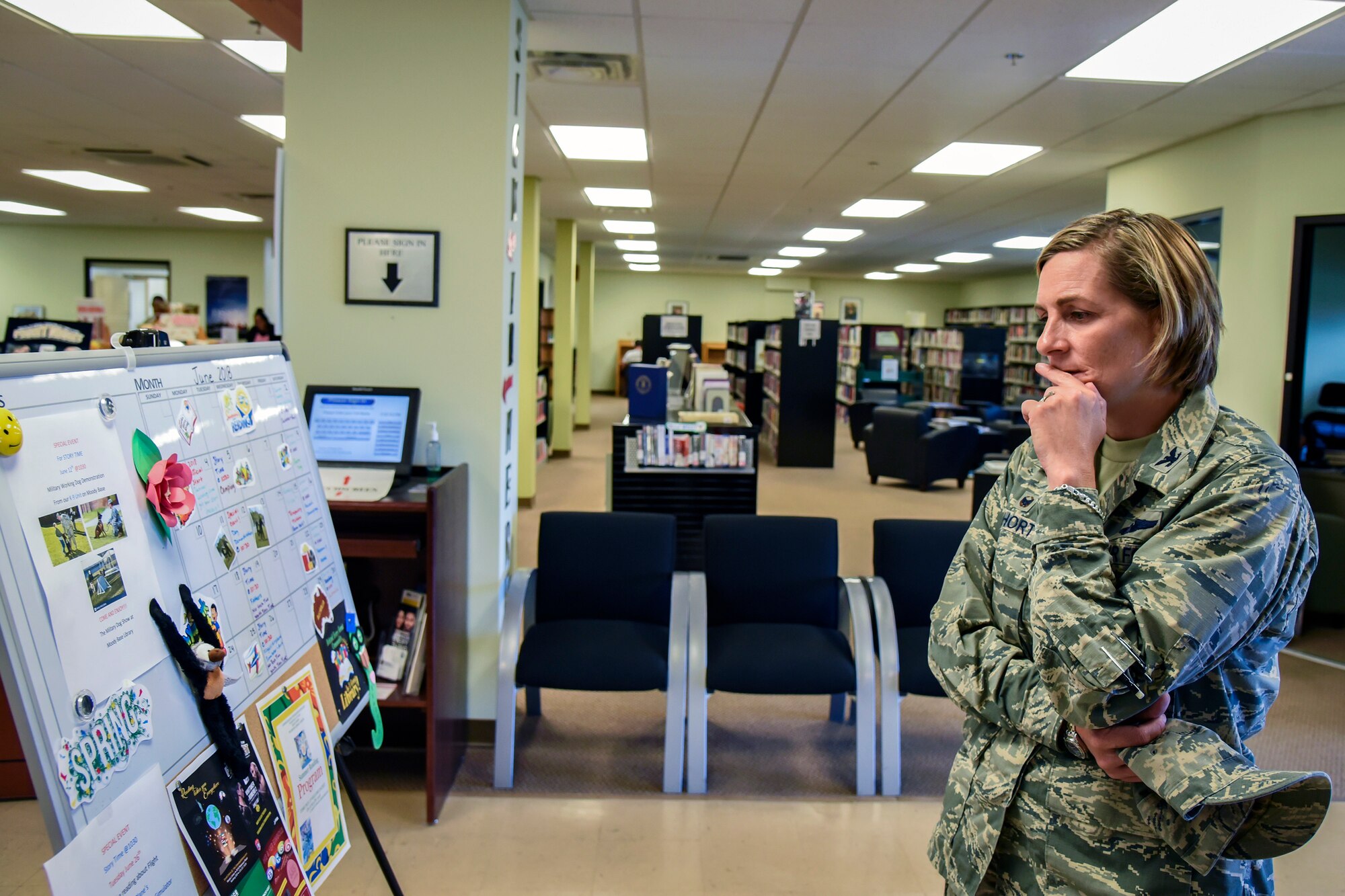 Col. Jennifer Short, 23d Wing (WG) commander, reads the schedule for the library of the Information Learning Center during an immersion tour, June 11, 2018, at Moody Air Force Base, Ga. Short and Chief Master Sgt James Allen, 23d WG command chief, toured the Georgia Pines Dining Facility and the ILC to gain a better understanding of their overall mission, capabilities and comprehensive duties. (U.S. Air Force photo by Airman 1st Class Eugene Oliver)