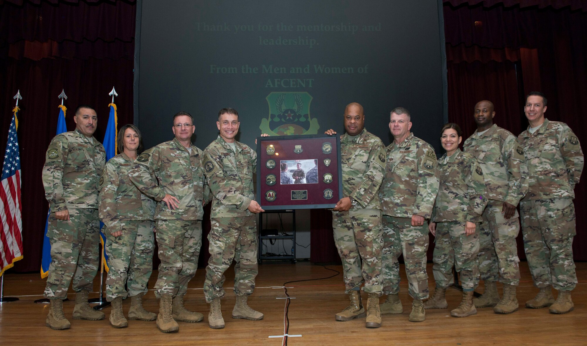 Members of United States Air Forces Central Command (AFCENT) present Chief Master Sgt. Joseph A. Montgomery, AFCENT command chief, a gift at Shaw Air Force Base, S.C., June 6, 2018.