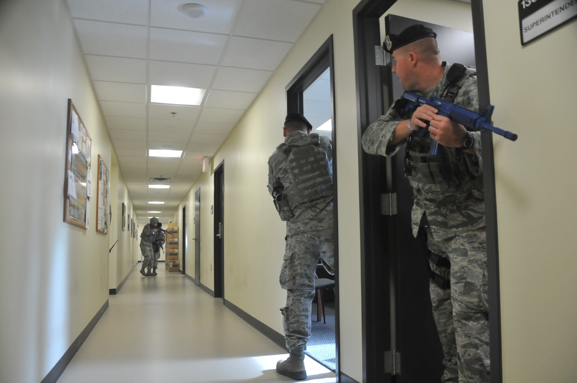 Security Forces Airmen with the 128th Air Refueling Wing, Wisconsin Air National Guard, clear a building after a simulated active shooter exercise Aug. 13, 2017.