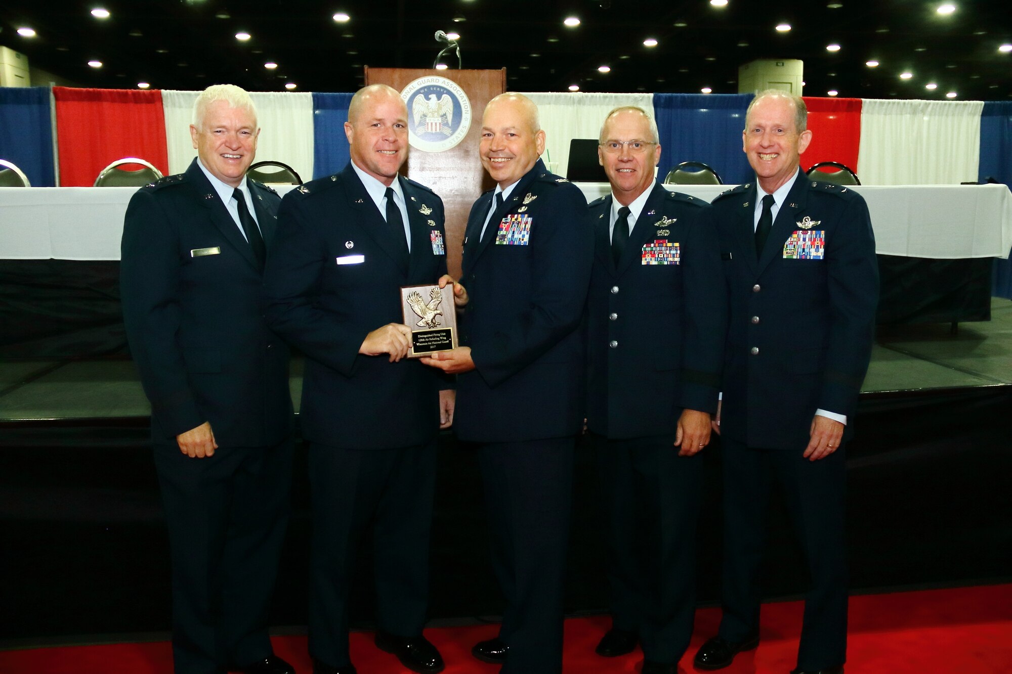 Col James Locke, 128 ARW wing commander, stands with Lt Gen L. Scott Rice, Air National Guard Director, and Wisconsin state leadership after being presented the NGAUS Distinguished Flying Unit at the 2017 General Conference & Exhibition Louisville, Kentucky, Sept. 10, 2017.