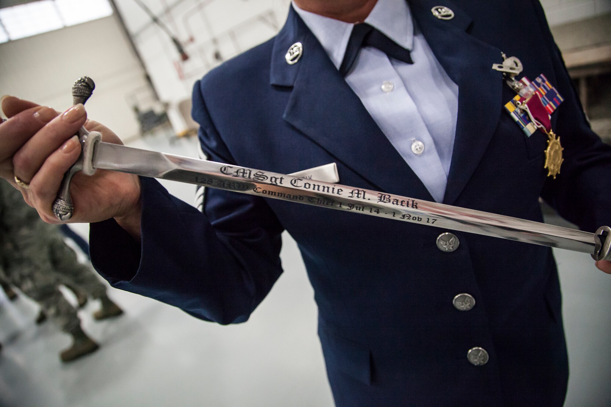 U.S. Air Force Command Chief Master Sgt. Connie Back shows off the Chief’s Saber presented to her by the men and women of the 128th Air Refueling Wing, Wisconsin Air National Guard Oct. 14, 2017.