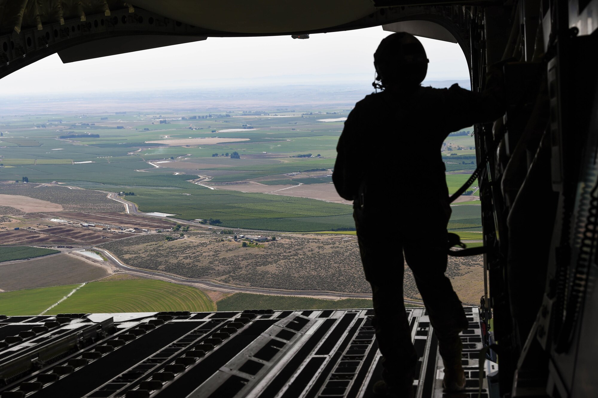 Airman 1st Class Samantha Martino, 7th Airlift Squadron loadmaster, prepares to drop a container delivery system bundle out of a C-17 Globemaster III onto the Rainier Drop Zone near Moses Lake, Wash., June 6, 2018. Martino was participating in Exercise Rainier War, which provided insights on how to better execute a tactical scenario for possible future conflicts. (U.S. Air Force photo by Senior Airman Tryphena Mayhugh)