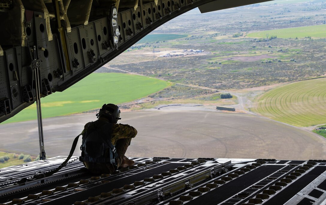 Staff Sgt. Matthew Duck, 7th Airlift Squadron loadmaster, sits on the ramp of a C-17 Globemaster III during Exercise Rainier War near Moses Lake, Wash., June 6, 2018. Participating in the execution portion of the exercise were 110 aircrew and mission essential personnel from the 4th AS, 7th AS and 62nd Operations Squadron. (U.S. Air Force photo by Senior Airman Tryphena Mayhugh)