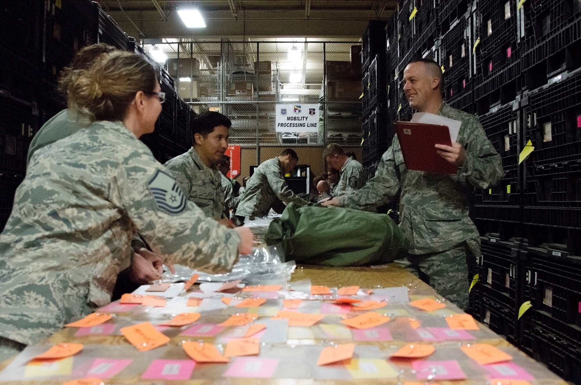 Airmen receive their assigned gear while processing through a deployment mobility line during a generation exercise at the 128th Air Refueling Wing, Wisconsin Air National Guard, Nov. 5, 2017.