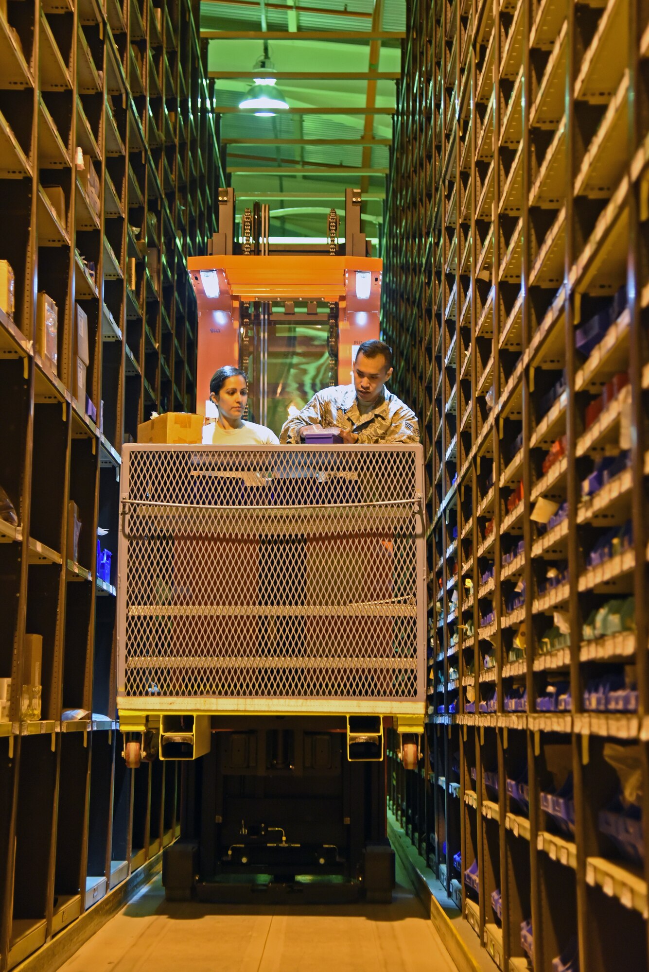 During a two-week training exercise, Airmen from the 161st and 48th Logistics Readiness Squadrons use a lift to search for and collect parts for customers at the supply warehouse at Royal Air Force Lakenheath, England May 29, 2018. The training exercise allowed members from Arizona Air National Guard to work alongside their active-duty counterparts from the 48th Fighter Wing to ensure mission readinesss.(U.S. Air National Guard photo by Staff Sgt. Dillon Davis)