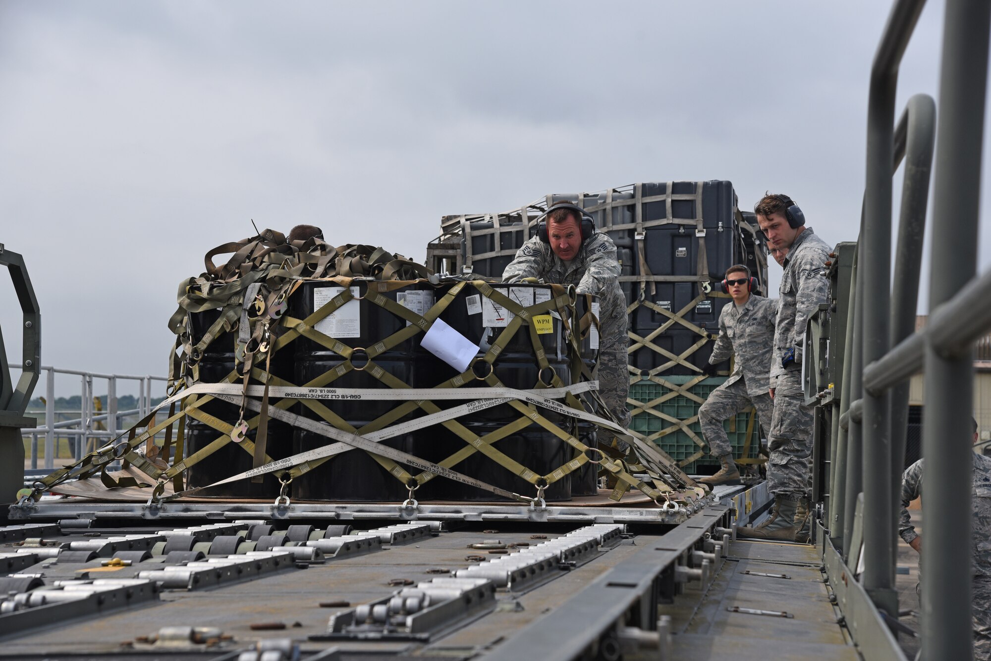 Airmen from the 161st Logistics Readiness Squadron push a palletized load onto a 60K loader during a two-week training exercise at Royal Air Force Lakenheath, England May 29, 2018. The Airmen were able to work alongside their active-duty counterparts at the 48th Logistics Readiness Squadron aerial port to get hands-on experience and training and improve overall mission readiness. (U.S. Air National Guard photo by Staff Sgt. Dillon Davis)