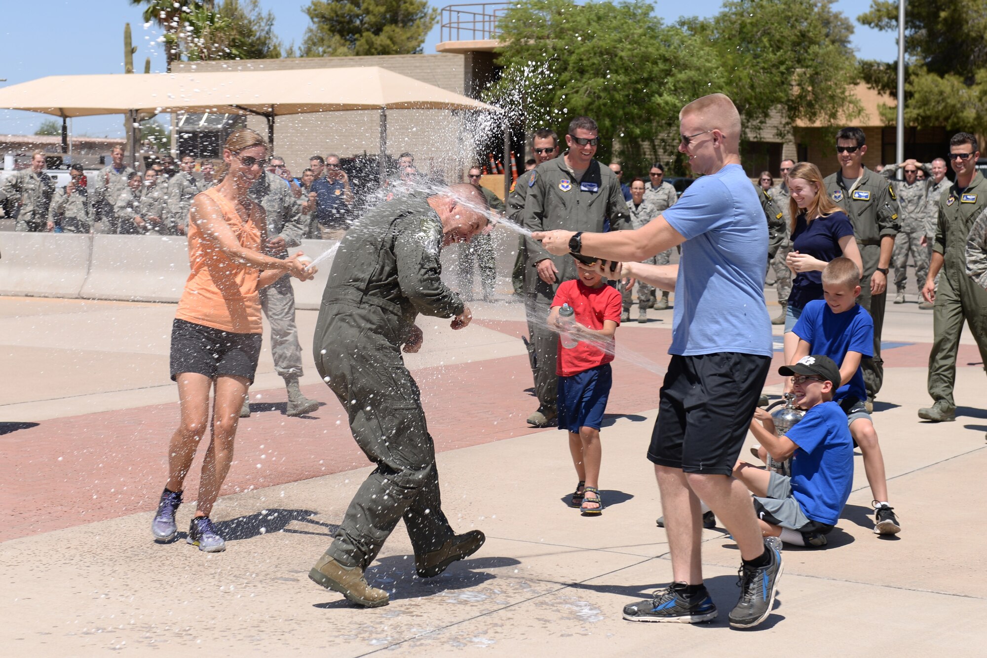 Brig. Gen. Brook Leonard, 56th Fighter Wing commander, is showered by his family in celebration of his final sortie at Luke Air Force Base, Ariz., June 8, 2018. A pilot’s final flight at an assignment is an occasion steeped in tradition and celebration. (U.S. Air Force photo by Senior Airman Ridge Shan)