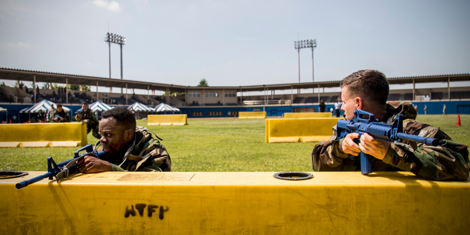 Maj. Logan Smith, 374th Civil Engineer Squadron operations flight commander, right front, shouts to Airmen to move forwards after providing simulated cover during an Ability to Survive and Operate (ATSO) Rodeo