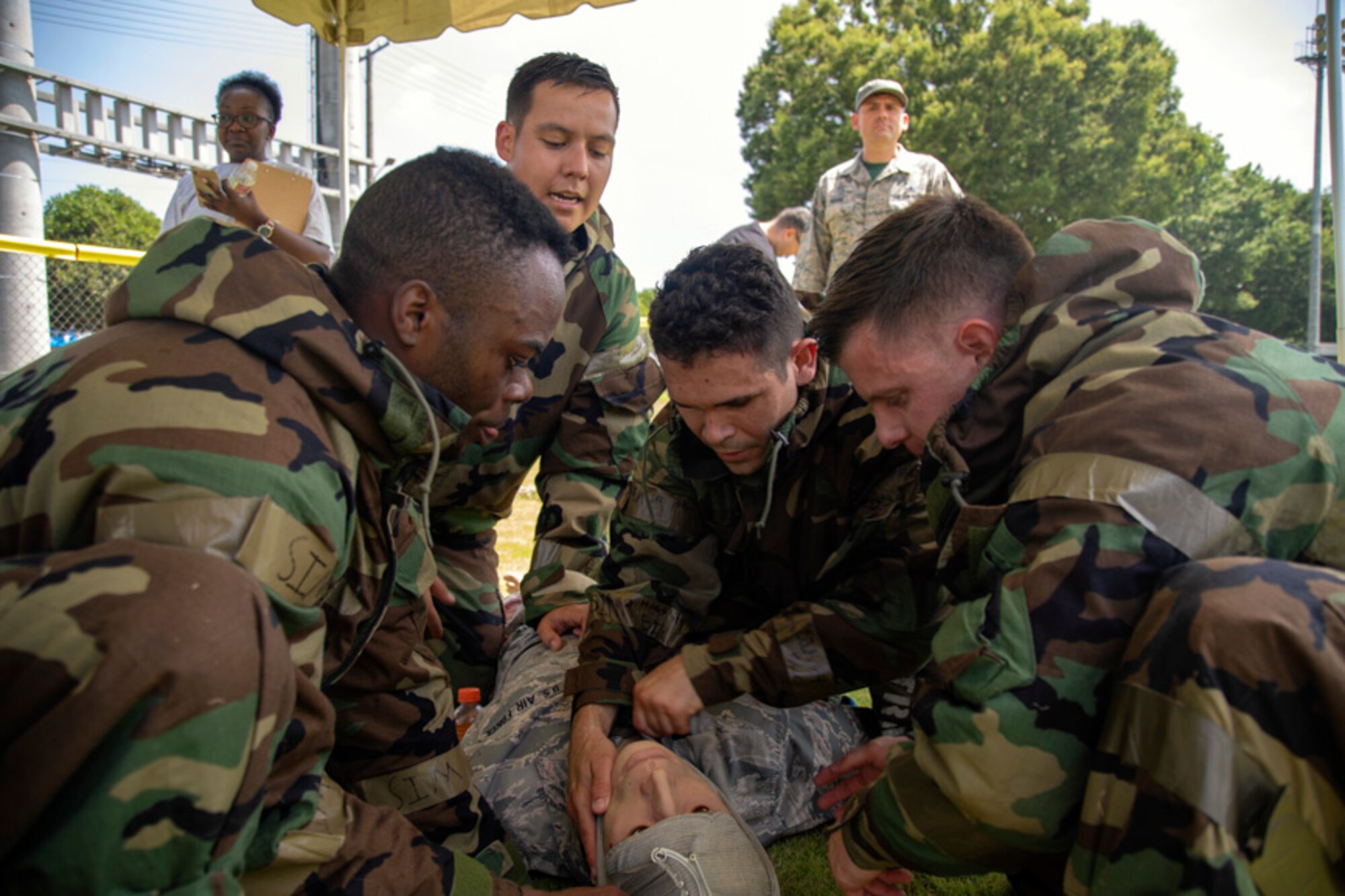 Airmen with the 374th Civil Engineer Squadron perform a self-aid and buddy care during an Ability to Survive and Operate (ATSO) Rodeo