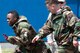 Maj. Logan Smith, 374th Civil Engineer Squadron operations flight commander, passes the baton to Senior Airman Felix Nunez, 374th CES electrical system technician, during an Ability to Survive and Operate (ATSO) Rodeo