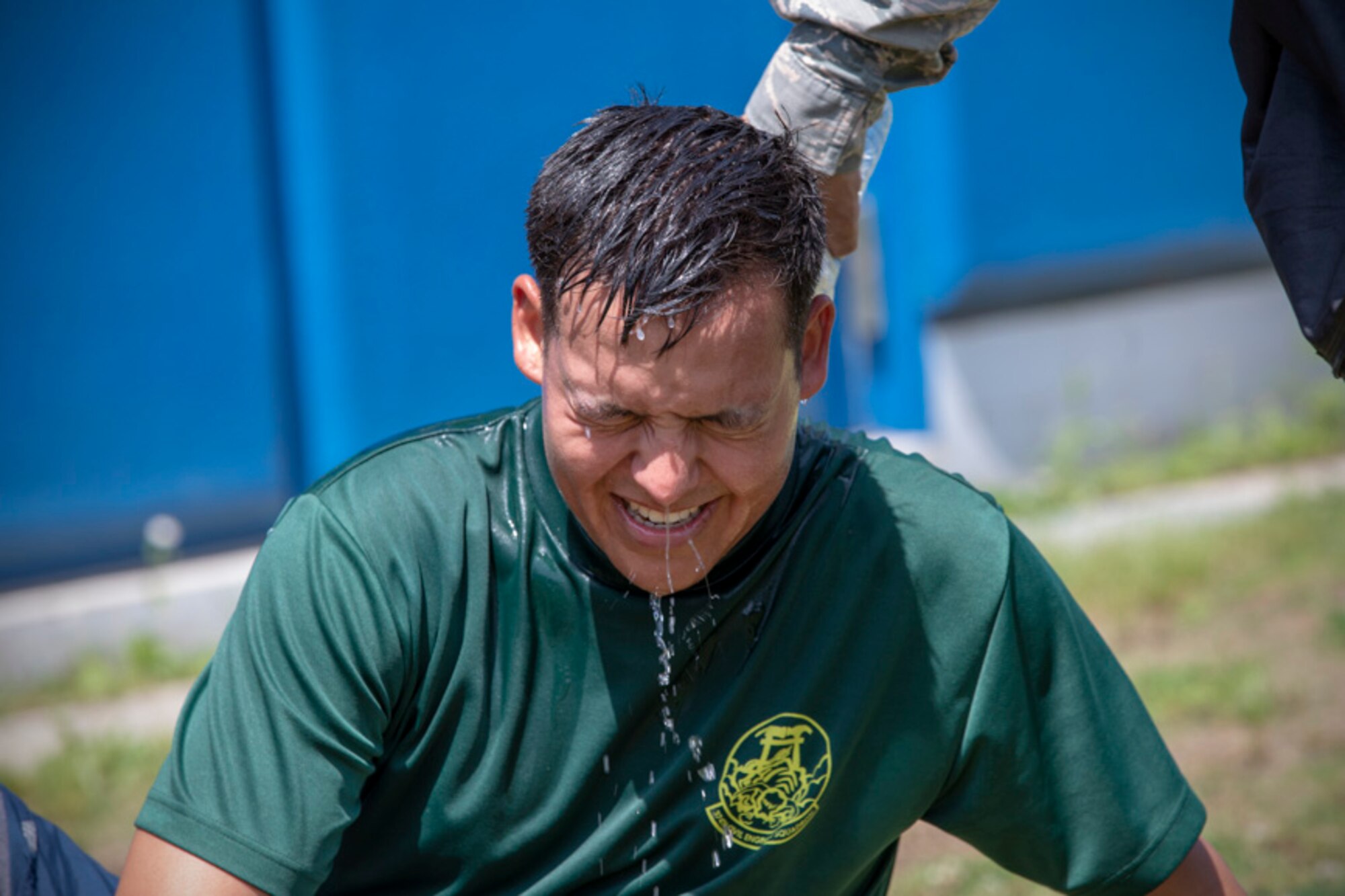 Airman 1st Class Matthew Byce, 374th Civil Engineer Squadron structural apprentice, gets drenched with a cold water after finished four-person relay during an Ability to Survive and Operate (ATSO) Rodeo