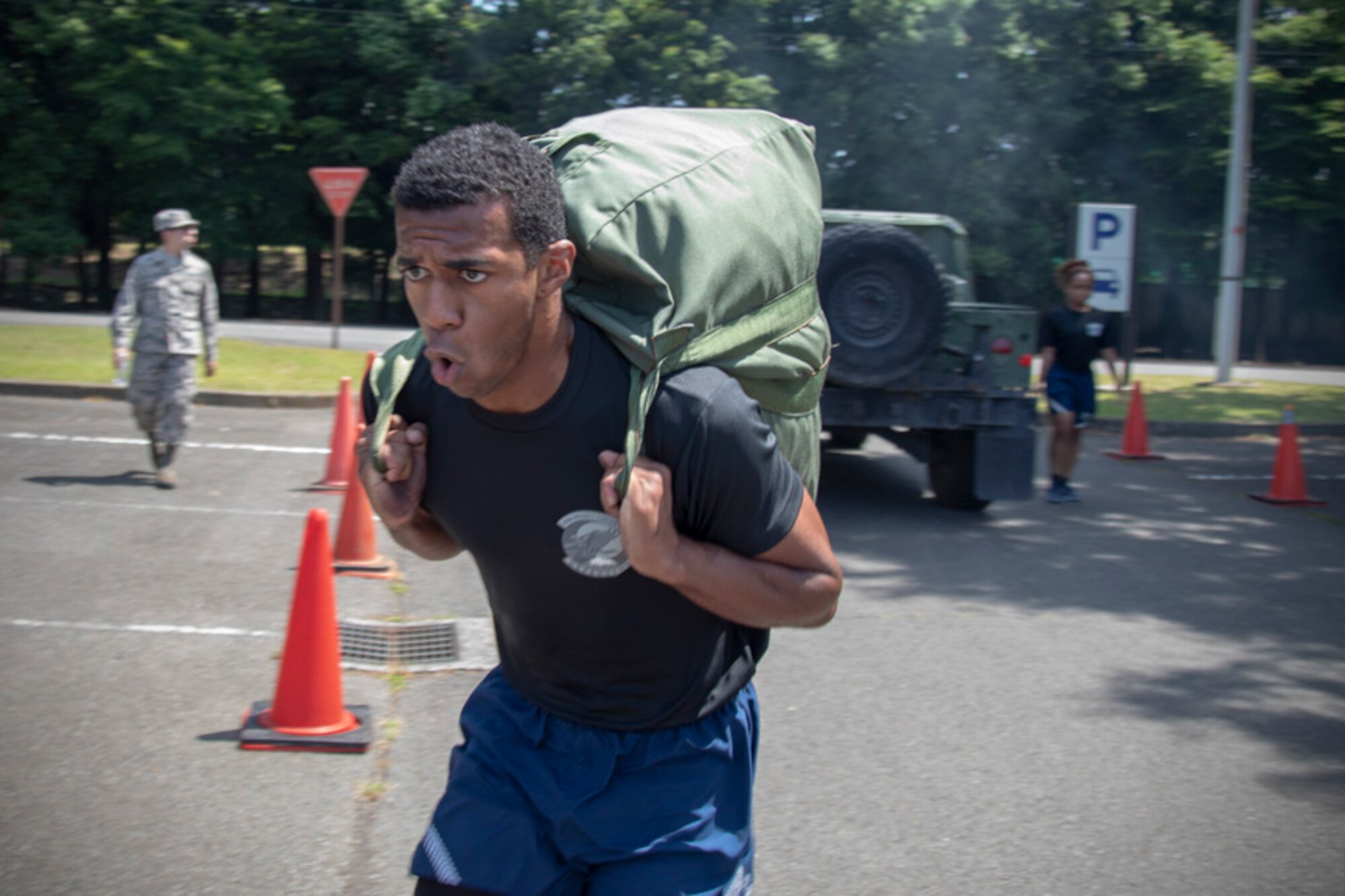 Senior Airman Antonio Gant, 374th Security Forces Squadron armorer, carries his chemical gear bag during an Ability to Survive and Operate (ATSO) Rodeo