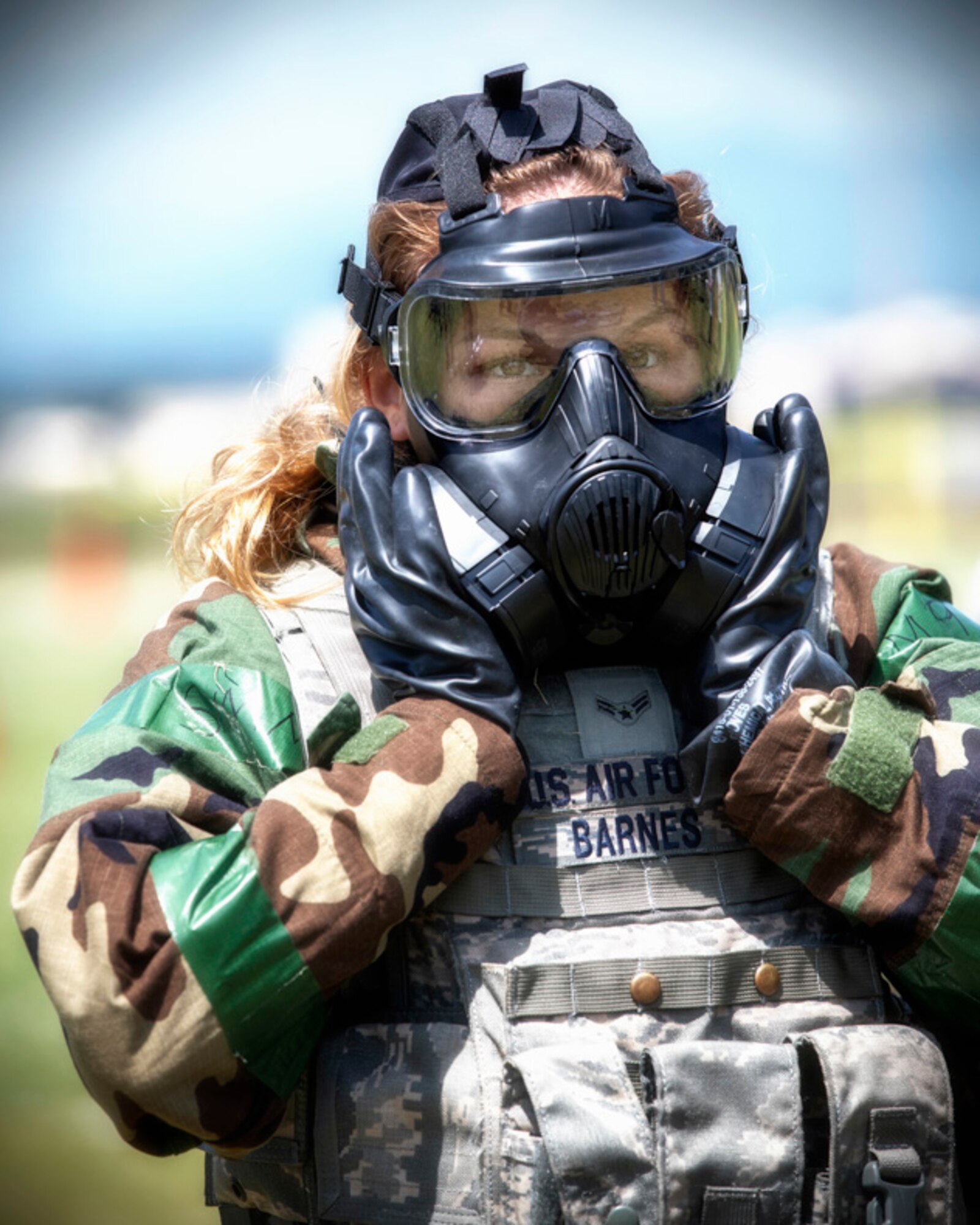 Airman 1st Class Hannah Barnes, 374th Security Forces Squadron patrolman, checks her gas mask seal during an Ability to Survive and Operate (ATSO) Rodeo