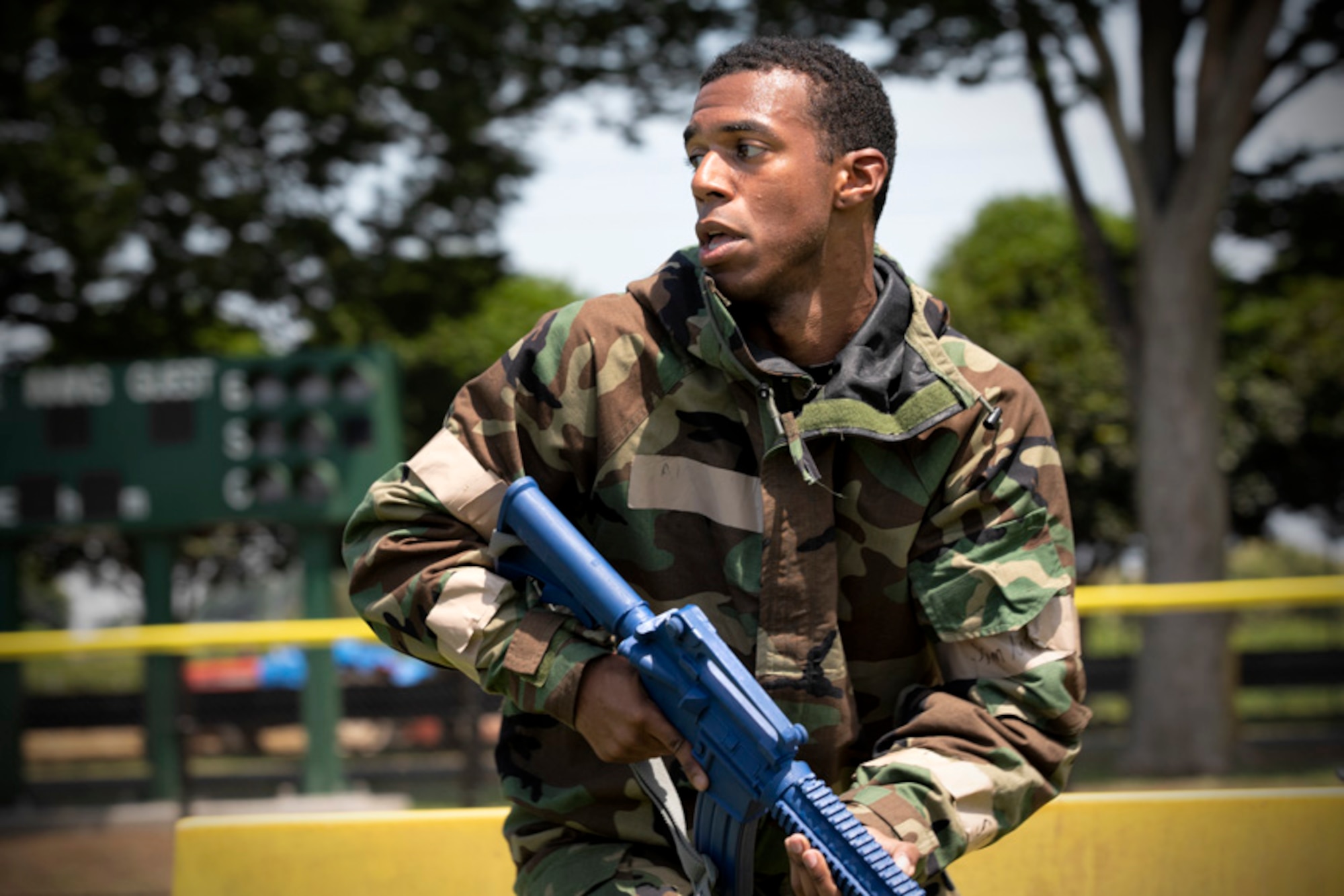 Senior Airman Antonio Gant, 374th Civil Engineer Squadron armorer, sprints into position during an Ability to Survive and Operate (ATSO) Rodeo