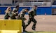 Airmen with the 374th Security Forces Squadron run to the next stage during an Ability to Survive and Operate (ATSO) Rodeo