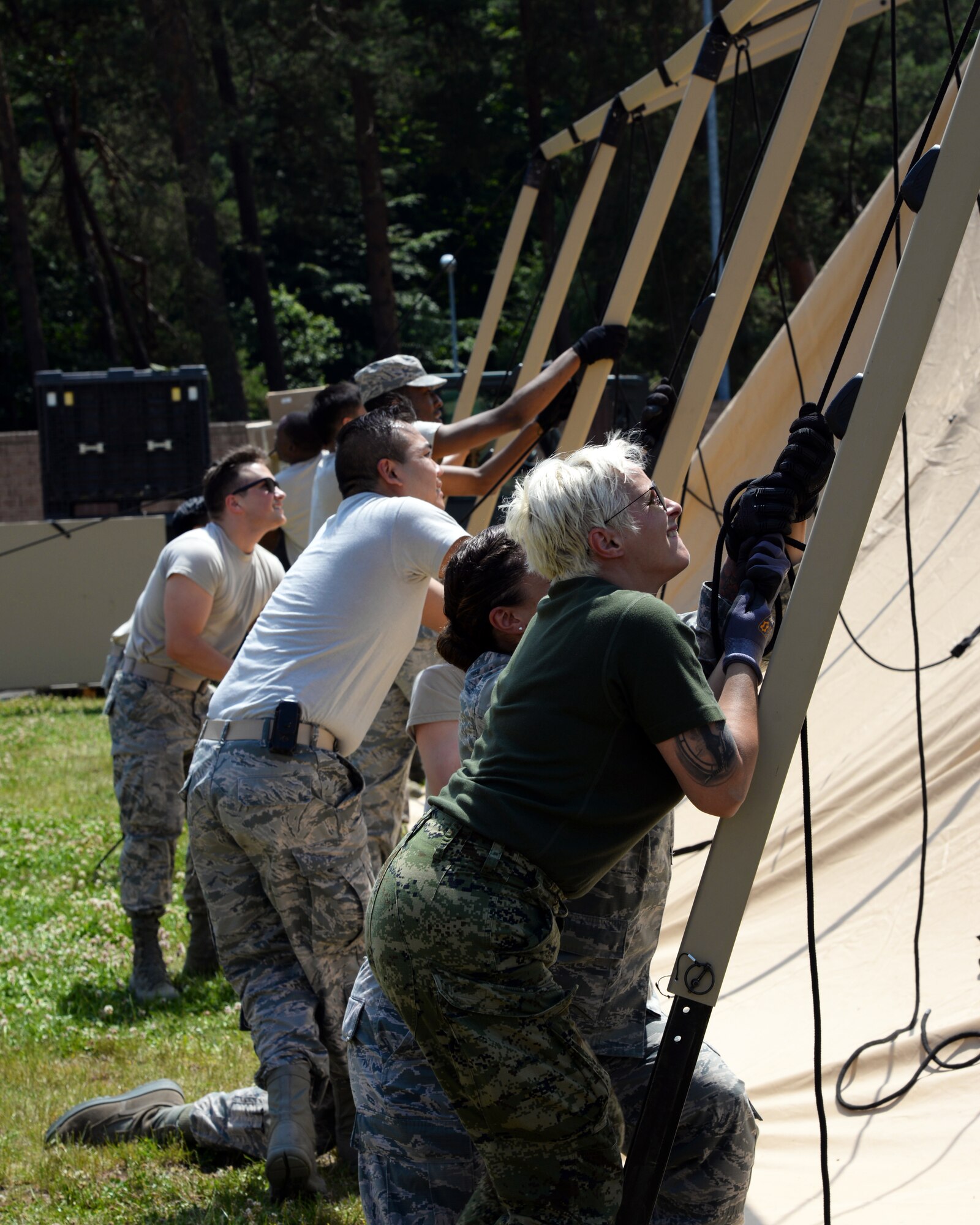 Airmen from the 86th Medical Group and 86th Logistics Squadron, joined by members of the Croatian armed forces, set up an Expeditionary Medical Support System modular field hospital during en route patient staging training during Exercise Maroon Surge on Ramstein Air Base, Germany, June 4, 2018. Designed for rapid mobility and efficient setup, EMEDS can deploy within 24 hours of notification, and establish emergency room capability in two hours, operating room capability in four hours, and critical care capability in six hours. (U.S. Air Force photo by Airman 1st Class Ariel Leighty)