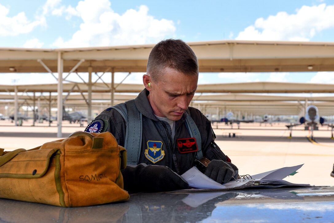 Lieutenant Colonel Mitchell Cok, 88th Fighter Training Squadron, recognized for Profession of Arms Center of Excellence Leadership Impact Award, goes over preflight check list before Introduction to Fighter Fundamentals training sortie at Sheppard Air Force Base, Texas, May 22, 2018 (U.S. Air Force/John Ingle)
