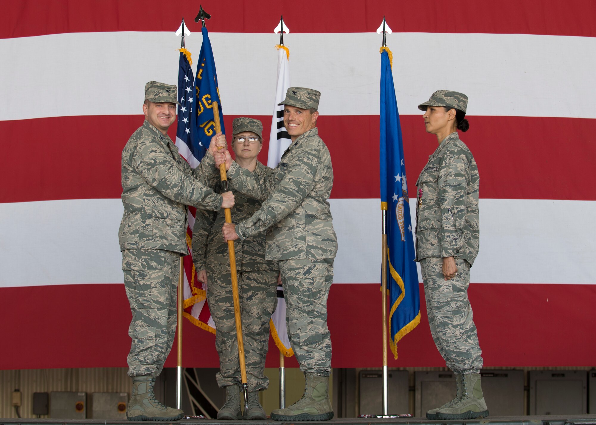 U.S. Air Force Col. Robert D. Peltzer, 8th Medical Group commander, receives the guidon from Col. John Bosone, 8th Fighter Wing commander, during a change of command ceremony June 13, 2018, at Kunsan Air Base, Republic of Korea. The 8th MDG is responsible for the medical care of approximately 2,700 active duty personnel and also maintains a specialty care network partnering with several civilian and military heath care facilities. (U.S. Air Force photo by Staff Sgt. Victoria H. Taylor)
