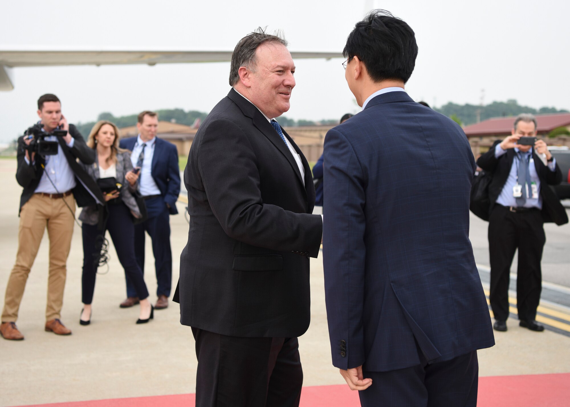 U.S. Secretary of State Mike Pompeo, center, arrives at Osan Air Base, Republic of Korea, June 13, 2018. During his visit, he will meet with senior South Korean and Japanese officials to discuss the U.S.-South Korea alliance, the U.S.-Japan alliance, shared priorities and the next steps in the ongoing, diplomatically-led efforts with the Democratic People's Republic of Korea. (U.S. Air Force photo by Airman 1st Class Ilyana A. Escalona)