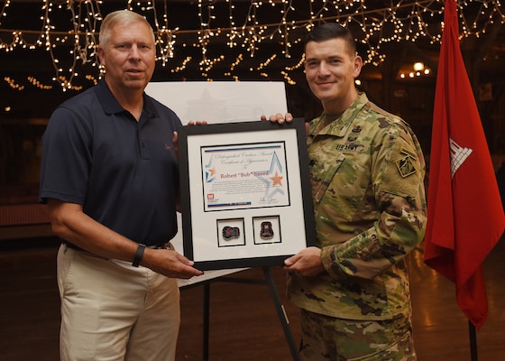Lt. Col. Cullen Jones (Right), U.S. Army Corps of Engineers Nashville District commander, presents the 2018 Distinguished Civilian Employee Recognition Award to Retiree Bob Sneed, former Water Management Section chief, during an award ceremony June 8, 2018 during the Engineer Day Picnic at Smiley Hollow in Ridgetop, Tenn. Sneed retired in 2016 following 36 years of federal service as a water manager in the Nashville District. (USACE photo by Lee Roberts)