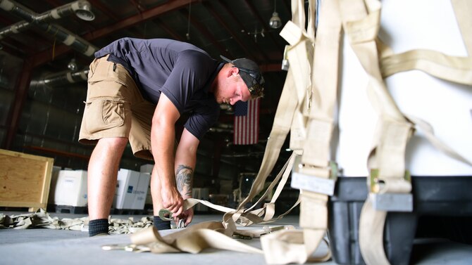 U.S. Army Sergeant William Poley, movements specialist, Joint Special Operations Forces Support Detachment – K, secures cargo to a pallet June 4, at an undisclosed location in Southwest Asia. (U.S. Air Force photo by Staff Sgt. Christopher Stoltz)