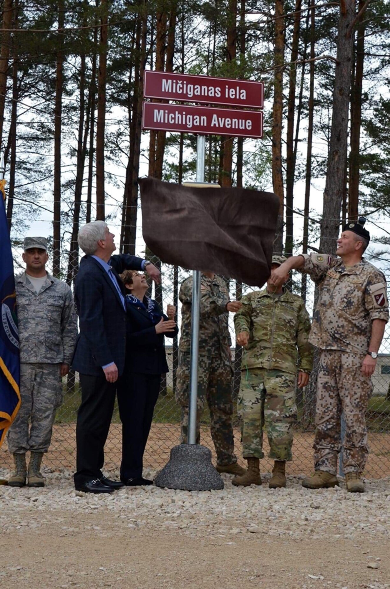 Michigan Gov. Rick Snyder, U.S. Ambassador to Latvia, Nancy Pettit, Adjutant General of Michigan, Maj. Gen. Gregory Vadnais, Latvian Armed Forces Commander, Lt. Gen. Leonīds Kalniņs, and Latvian Infantry Brigade commander, Col. Ilmārs Lejiņš, unveil “Michigan Avenue” at Ādaži Military Base, Latvia, June 12, 2018, to commemorate the 25-year relationship between Latvia and Michigan under the U.S. National Guard Bureau's State Partnership Program (SPP).