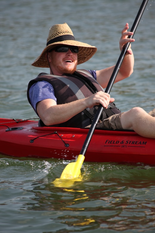 Kayaker enjoys Wilson Lake. Note the life jacket, sun protection and the smile. Whether on a lake or river, please stay safe!