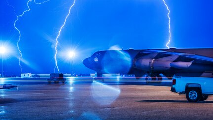 Lightning strikes behind B-52H Stratofortress at Minot Air Force Base, N.D., Aug. 8, 2017. . During lightning storms, personnel are reminded to stay sheltered in buildings, underground shelters or automobiles.