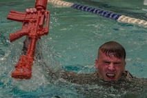 U.S. Air Force Airman 1st Class Colin Matz, 633rd Security Forces Squadron entry controller, recovers equipment during water confidence training during the emergency services team tryouts at Joint Base Langley-Eustis, Virginia, June 8, 2018. The EST mission is to combat any terrorist activity, high risk response or high risk activity. (U.S. Air Force photo by Senior Airman Derek Seifert)