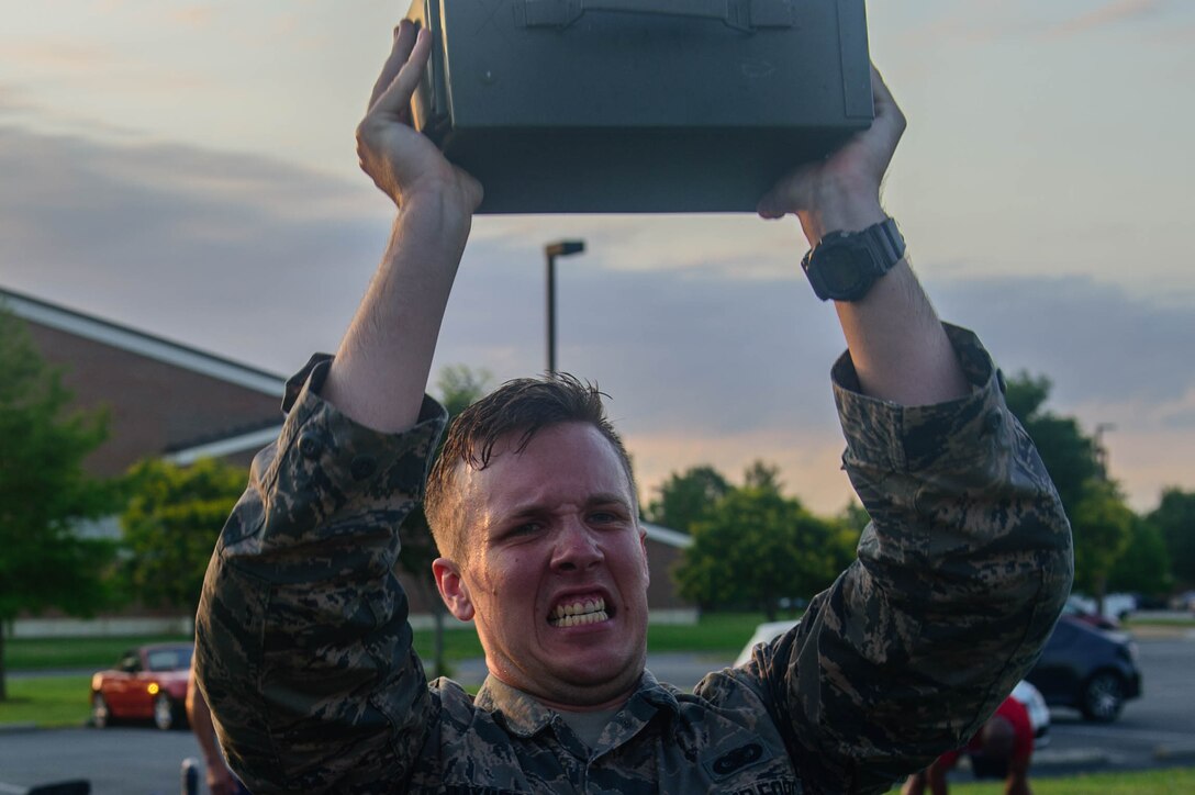 U.S. Air Force Airman Matthew Raymer, 633rd Security Forces Squadron entry controller, performs ammo can presses during the emergency services team tryouts at Joint Base Langley-Eustis, Virginia, June 8, 2018. The tryouts last approximately 24 hours and include water confidence, a fitness obstacle course, a 3-mile ruck march, hand-to-hand combat and other combat drills. (U.S. Air Force photo by Senior Airman Derek Seifert)