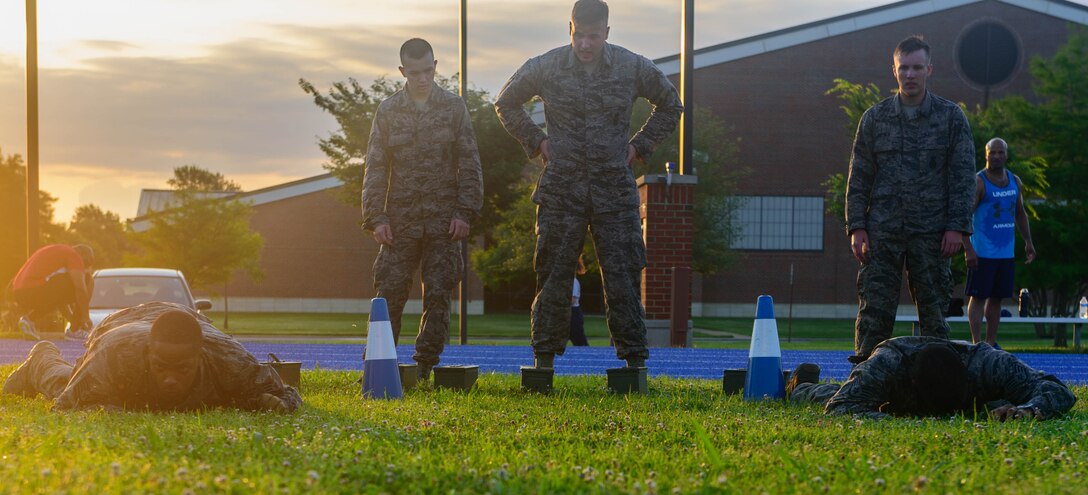 U.S. Air Force Airmen assigned to the 633rd Security Forces Squadron, low crawl during the emergency services team tryouts at Joint Base Langley-Eustis, Virginia, June 8, 2018. The team provides services equal to a civilian police SWAT (Special Weapons and Tactics) Team for the installation. (U.S. Air Force photo by Senior Airman Derek Seifert)