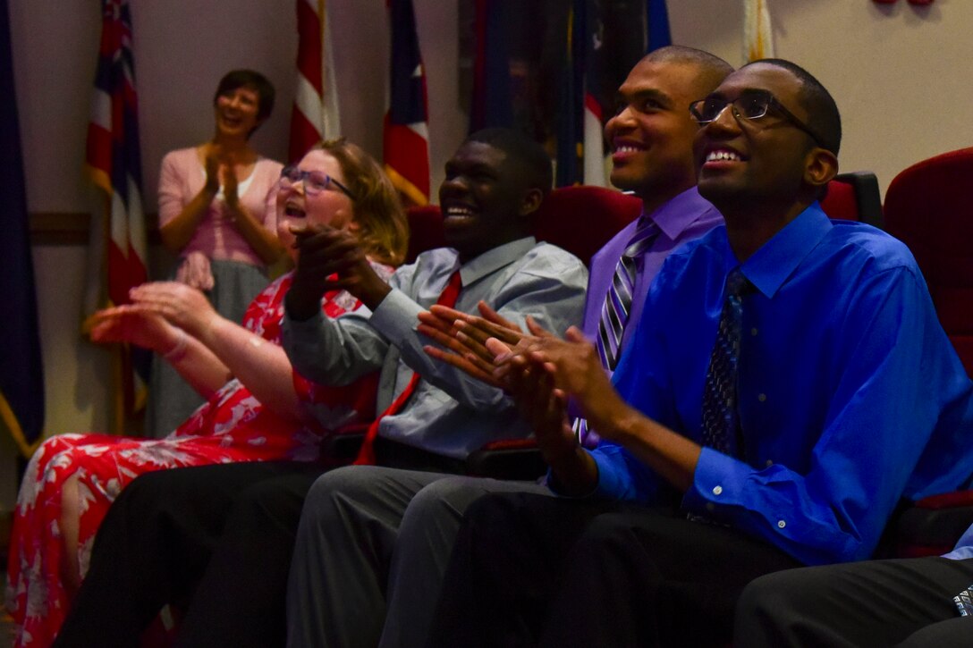 Project SEARCH graduates laugh during a presentation in Fort Eustis’ Wylie Theater at Joint Base Langley-Eustis, Virginia, June 7, 2018. The graduates spent their senior year of high school learning job skills while interning at various locations on Fort Eustis. (U.S. Air Force photo by Airman 1st Class Monica Roybal)