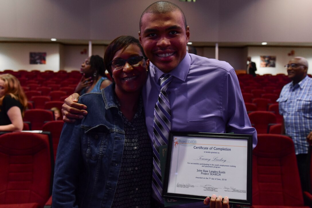 U.S. Army Sgt. 1st Class Rhonda Gayle, U.S. Army Training and Doctrine Command Inspector General assistant inspector general and her son, Tommy Lindsey, pose for a photo in Fort Eustis’ Wylie Theater at Joint Base Langley-Eustis, Virginia, June 7, 2018. Lindsey graduated Project SEARCH with a job offer from General Smalls Inn. (U.S. Air Force photo by Airman 1st Class Monica Roybal)
