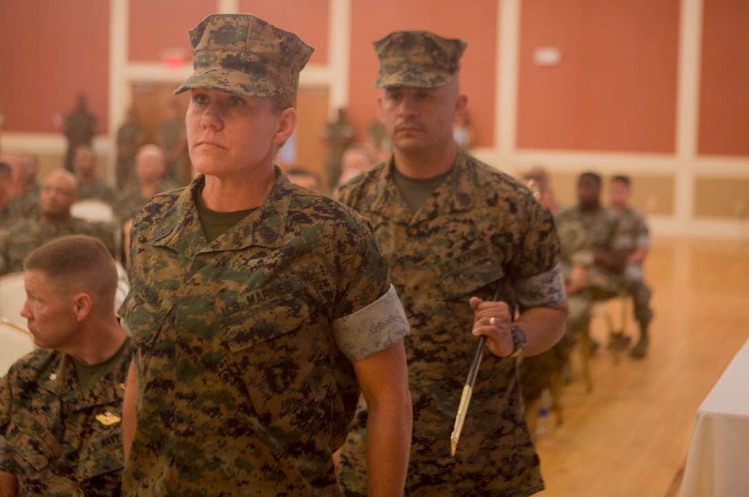 U.S. Marine Corps Sgt. Maj. Joy M. Kitashima and Sgt. Maj. Rene Salinas with II Marine Expeditionary Force Information Group (MIG) prepare to pass the noncommissioned officer sword during a post and relief ceremony at Camp Lejeune, N.C., June 8, 2018. After 30 years of service, Salinas retired and relinquished his duties of II MIG sergeant major to Kitashima. (U.S. Marine Corps photo by Lance Cpl. Tanner Seims)