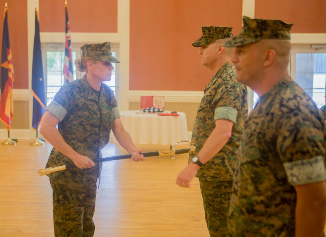 U.S. Marine Corps Sgt. Maj. Joy M. Kitashima with II Marine Expeditionary Force Information Group (MIG) receives the staff noncommissioned officer sword from Sgt. Maj. Rene Salinas during a relief and appointment ceremony at Camp Lejeune, N.C., June 8, 2018. After 30 years of service, Salinas retired and relinquished his duties of II MIG sergeant major to Kitashima. (U.S. Marine Corps photo by Lance Cpl. Tanner Seims)