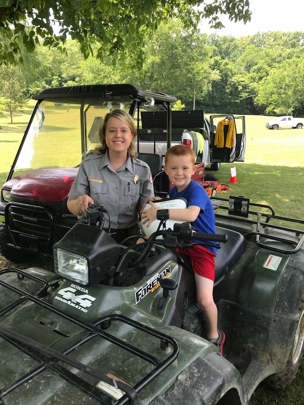 Park Ranger Ashley Webster shows a young boy the all-terrain vehicles the Corps of Engineers use when doing trail work during the “Touch a Truck” event June 9, 2018 at Cordell Hull Lake in Carthage, Tenn. (Courtesy Asset)