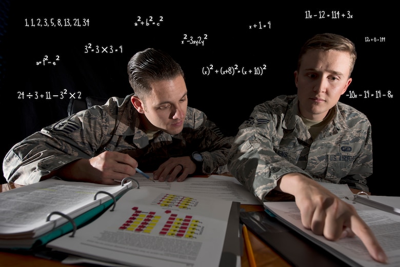 Staff Sgt. Lee Rimell, noncommissioned officer in charge of financial management operations, and Senior Airman Nathan Saelens, financial management technician, both with the 50th Comptroller Squadron, discuss homework assignments in a classroom at Schriever Air Force Base, Colorado, June 12, 2018. Rimell and Saelens have successfully completed the Math Concepts course offered through Colorado Christian University via Schriever AFB’s Professional Development Center. The next session of the course begins July 24. (U.S. Air Force photo illustration by Staff Sgt. Matthew Coleman-Foster)
