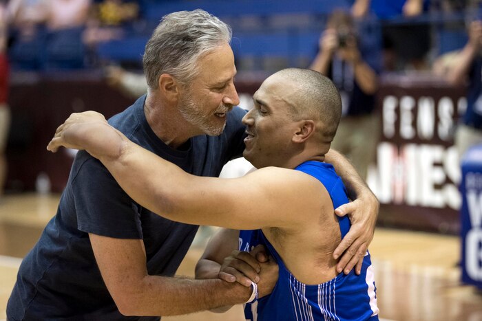 Jon Stewart greets an Air Force competitor during the 2018 Department of Defense Warrior Games gold medal wheelchair basketball round.