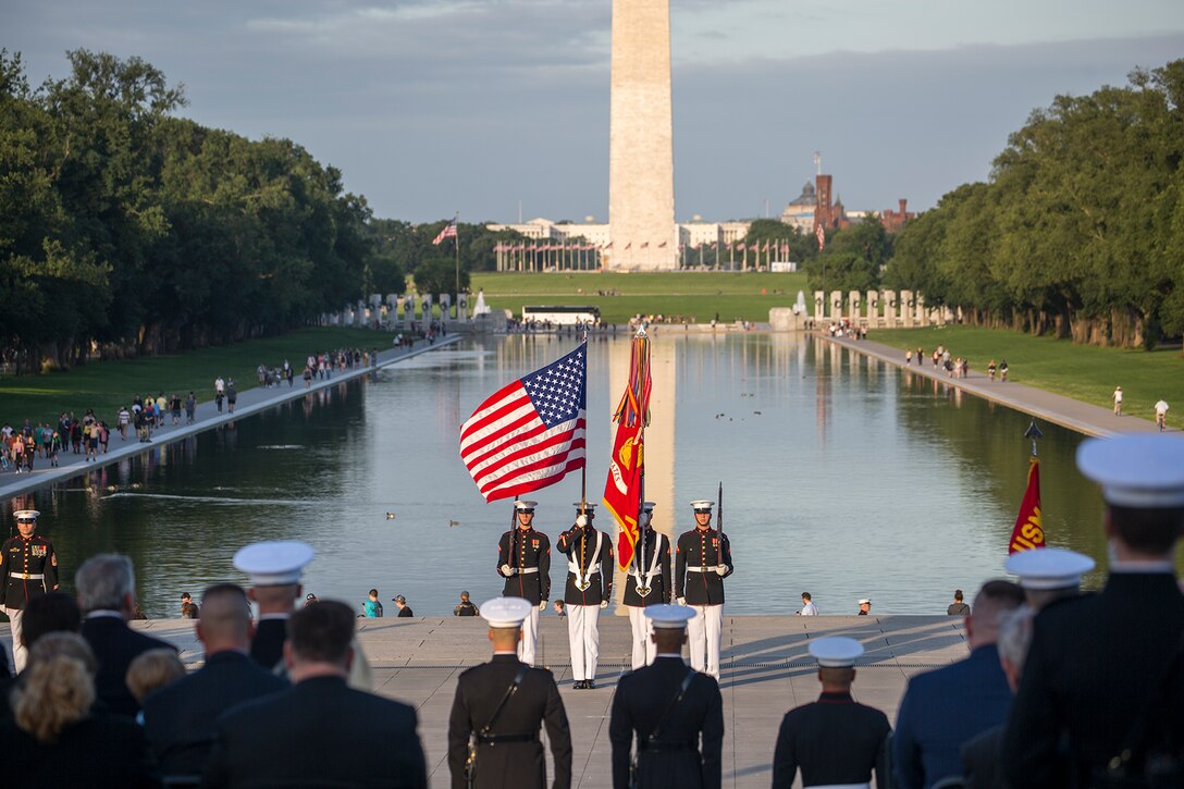 Marines with the U.S. Marine Corps Color Guard present the National Ensign during the playing of the National Anthem during the Sunset Parade at the Lincoln Memorial, Washington D.C., June 12, 2018.