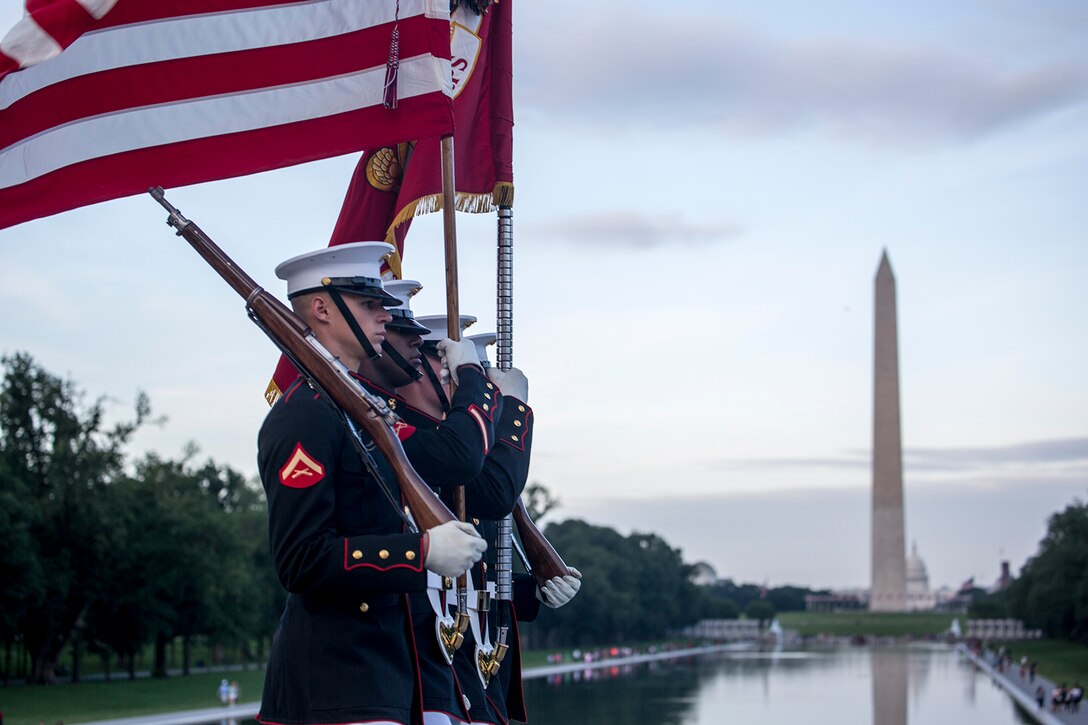 Marines with the U.S. Marine Corps Color Guard march the National Ensign and the U.S. Marine Corps Battle Colors across the parade deck during the Sunset Parade at the Lincoln Memorial, Washington D.C., June 12, 2018. This year is the first year the Barracks Marines are hosting Tuesday Sunset Parades at the Lincoln Memorial. The guest of honor for the parade was Secretary of the Interior Ryan Zinke and the hosting official was Robert D. Hogue, counsel for the commandant of the Marine Corps. (Official U.S. Marine Corps photo by Sgt. Robert Knapp/Released)