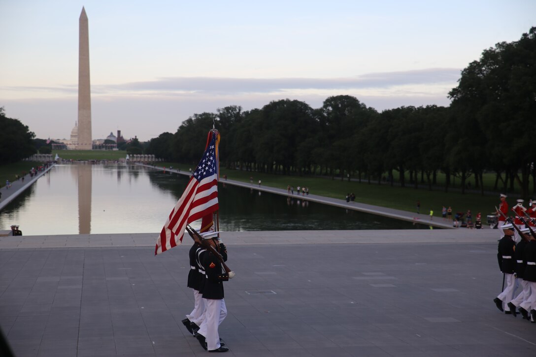 Marines with the U.S. Marine Corps Color Guard march the National Ensign and the U.S. Marine Corps Battle Colors across the parade deck during the Tuesday Sunset Parade at the Lincoln Memorial, Washington D.C., June 12, 2018. This year is the first year Barracks Marines are hosting Tuesday Sunset Parades at the Lincoln Memorial. The guest of honor for the parade was Secretary of the Interior Ryan Zinke and the hosting official was Robert D. Hogue, counsel for the commandant of the Marine Corps.