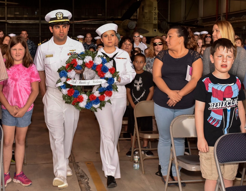 Sailors hold a commemorative wreath during the 76th Battle of Midway commemoration ceremony on Joint Base McGuire-Dix-Lakehurst, N.J., June 5, 2018. In addition to the 300 service members who attended, classes from two local elementary schools visited to watch the ceremony and learn more about the infamous battle.
