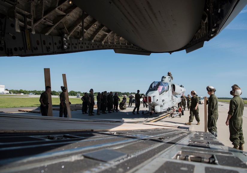 Marines with the Marine Light Attack Helicopter Squadron 773 prepare to load an AH-1 SuperCobra into a U.S. Air Force C-17 Globemaster III during day one of the 2018 Marine Aircraft Group-49 Combined Arms Exercise on Joint Base McGuire-Dix-Lakehurst, N.J., June 12, 2018. The MCAX is a large-scale exercise that utilizes ground forces, aviation assets, indirect fires and other enablers in an effort to train air and ground forces together. (U.S. Air Force photo by Airman Ariel Owings)