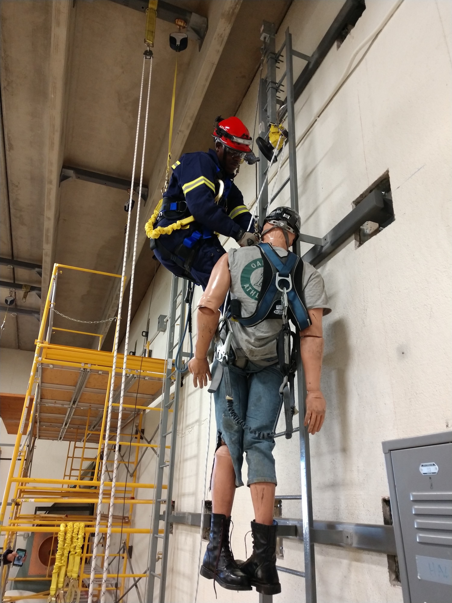 Senior Airman LeJarrell Evans, 90th Civil Engineer Squadron firefighter, preforms a ladder rescue at the Laramie County Community College Climb Safety Lab, Cheyenne, Wyo., June 5, 2018. F.E. Warren has three wind turbines located on base, however no one was certified in rescue and recovery. Four firefighters recently took a course through Laramie County Community College on the various stages of recovery on a wind turbine and received a two-year certification. (Courtesy Photo)