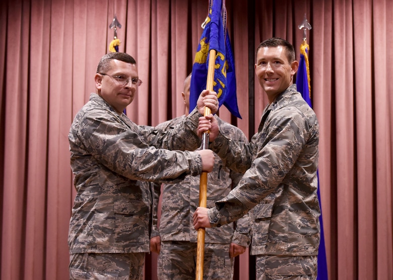 U.S. Air Force Col. David Williams, 39th Mission Support Group commander, passes the guidon to Capt. Joseph Misch as he assumes command of the 39th Contracting Squadron during a change of command ceremony at Incirlik Air Base, Turkey, June 13, 2018.