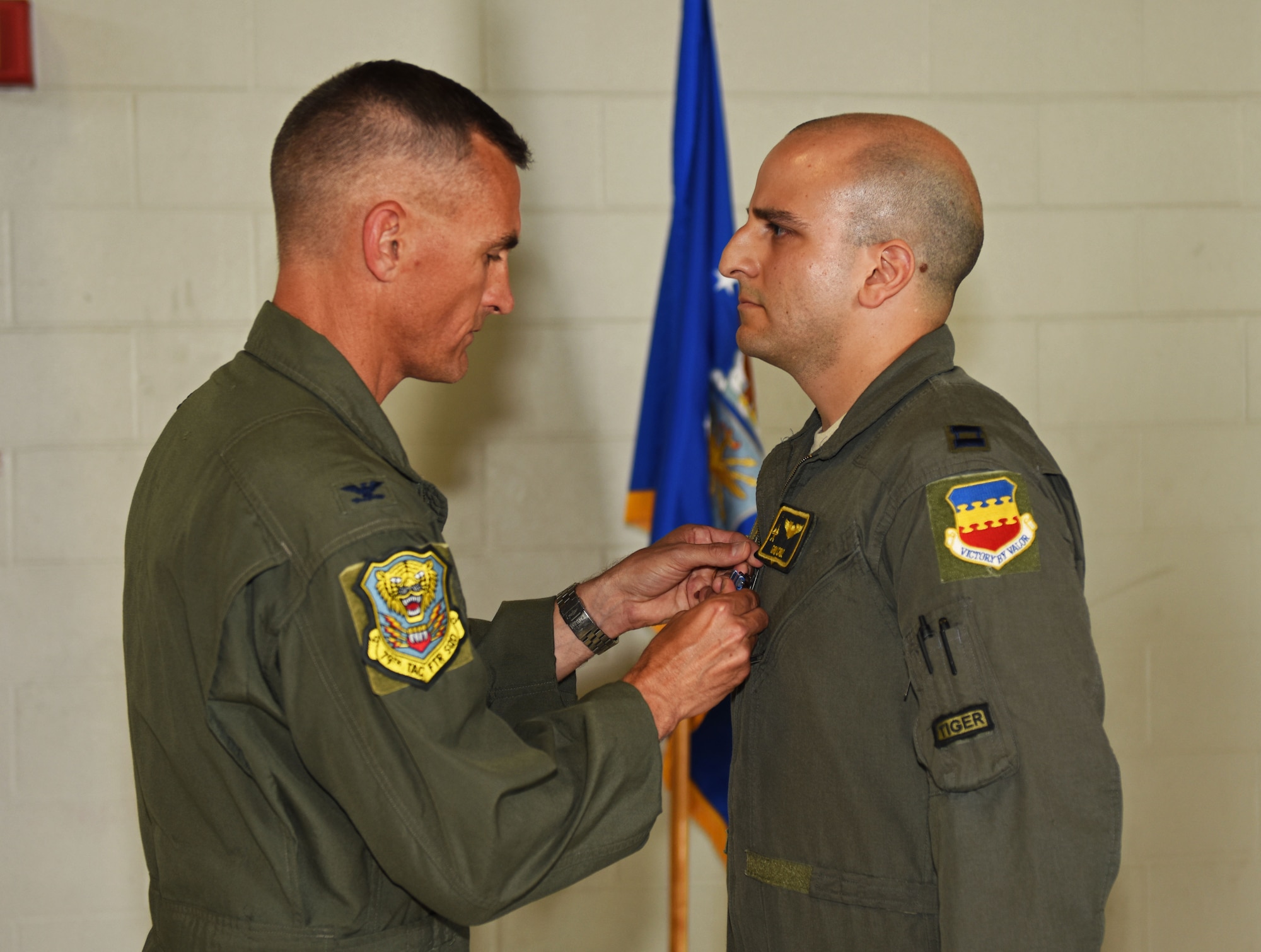 U.S. Air Force Col. Daniel Lasica, former 20th Fighter Wing commander, presents the Distinguished Flying Cross (DFC) to Capt. Salvador A. Cruz, 79th Fighter Squadron instructor pilot, at Shaw Air Force Base, S.C., June 7, 2018.