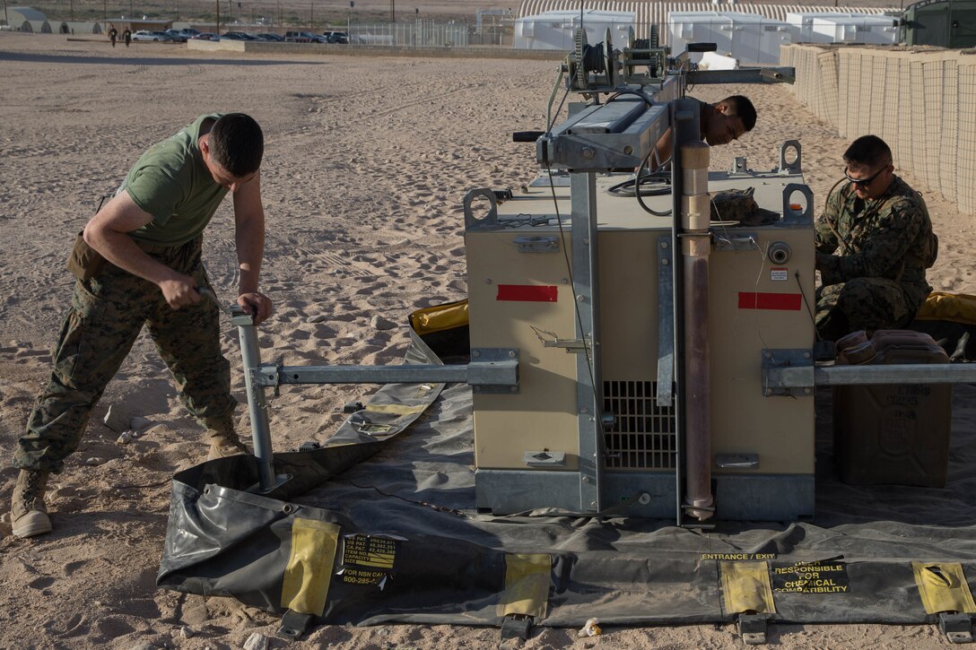 Lance Cpl. Eli Sommers, a refrigeration and air conditioning technician with Utilities, CLR-45, 4th MLG, ensures a floodlight base is stabilized before raising the light while during Integrated Training Exercise 4-18 at Marine Corps Air Ground Combat Center Twentynine Palms, California, June 12, 2018.