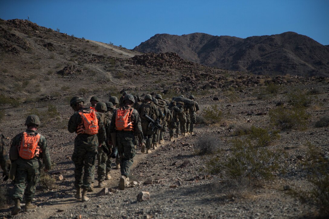 Infantry assault Marines and machine gunners with Bravo Company, 1st Battalion, 23rd Marine Regiment, 4th Marine Division, prepare to attack Machine Gun Hill on range 410A, a platoon reinforced attack range, during Integrated Training Exercise 4-18 at Marine Corps Air Ground Combat Center Twentynine Palms, California, June 12, 2018.